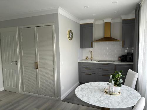 a kitchen with a table and a kitchen with a counter at Apartment Hartenrod in Bad Endbach