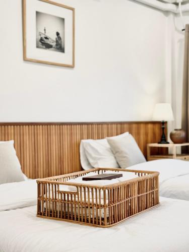 a wicker basket sitting on top of a bed at Momento Hotel and Cafe in Khon Kaen