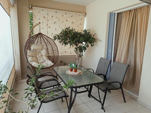 a dining room with a table and chairs at Nefeli's Home- Family luxury apartment in Heraklio Town