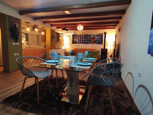 a dining room with a table and four chairs at Katia 's Country House in Sikión