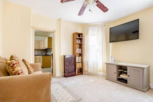 a living room with a couch and a flat screen tv at Hollywood in East Orange
