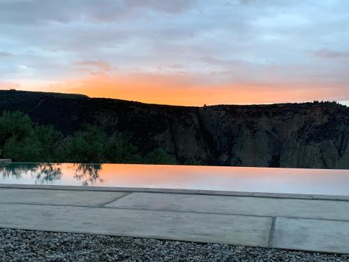 a body of water with the sunset in the background at Olive Guest Farm in Akrata