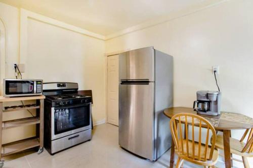a kitchen with a stainless steel refrigerator and a table at Hollywood in East Orange