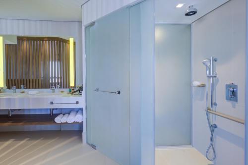 a bathroom with a shower and a sink at Radisson São Paulo Paulista in Sao Paulo