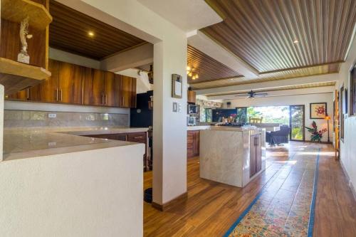 a kitchen with wooden cabinets and a counter top at Ocean and Jungle views! AC, Wi-Fi, kitchen in Manzanillo
