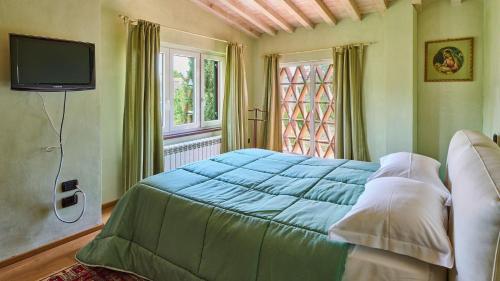 a bedroom with a blue bed and a window at Casa Rocchi in Capannori