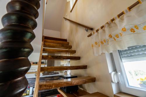 a spiral staircase in a tiny house with a window at WeinSpitz - Wellness House in Miklavž pri Ormožu
