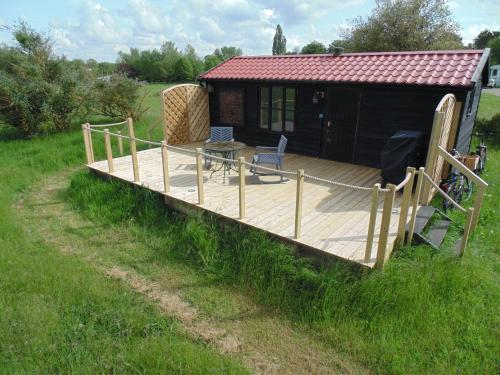 a large wooden deck in front of a cabin at The Cabin in Pakenham
