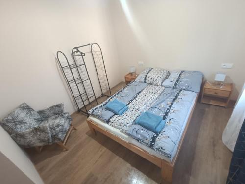 a bedroom with a bed and a chair at Apartamenty Lubkowo in Lubkowo