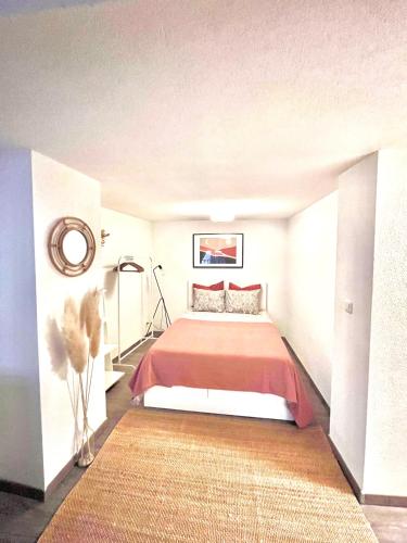 a bedroom with a bed with a red blanket at Franziskaner Suites #12 in Graz