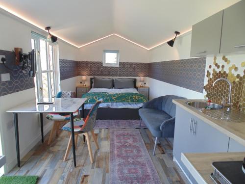 a small bedroom with a bed and a table at The Cabin in Pakenham