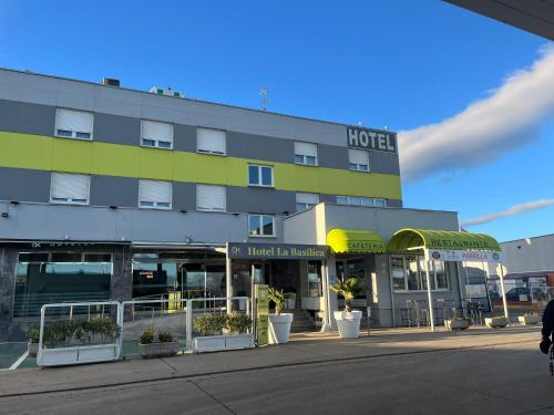 a hotel on a street in front of a building at Hotel La Basílica in Venta de Baños