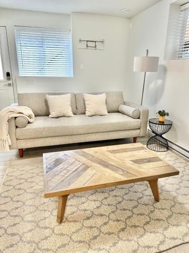 a living room with a couch and a coffee table at Homelike & cozy suite in Langley