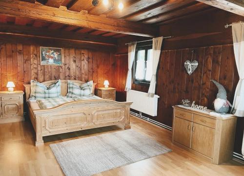a bedroom with a large bed and wooden walls at Uriges Bauernhaus mit Blick auf Graz in Graz