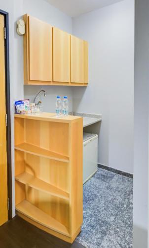 a kitchen with a counter with two water bottles on it at Radisson São Paulo Paulista in Sao Paulo