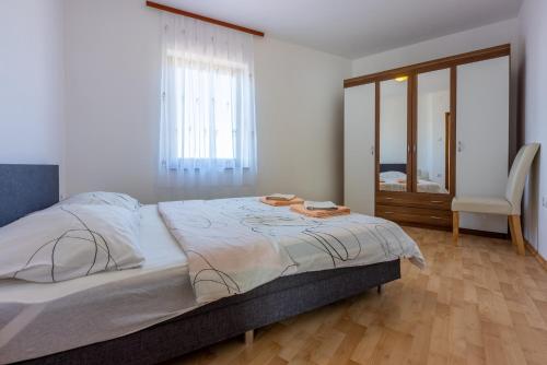 a bedroom with a large bed with a table on it at Family house with swimming pool in Novi Vinodolski