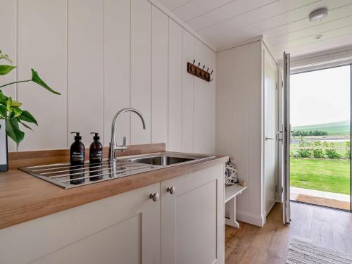 a kitchen with a sink and a large window at 2 Bed in St Andrews 94606 in St Andrews