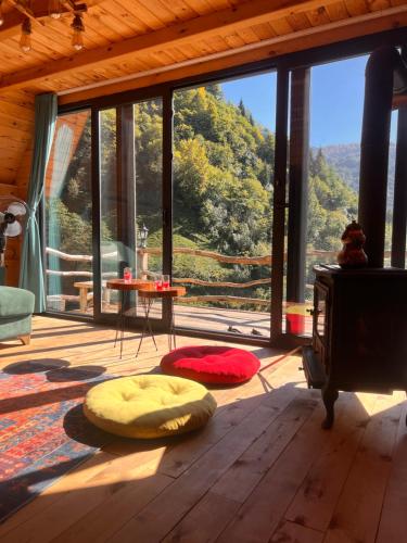 a living room with a view of a mountain at Northland Bungalows in Çayırdüzü