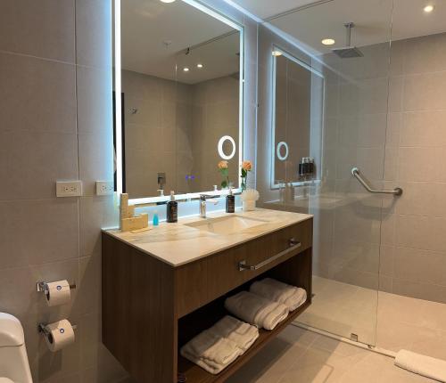 a bathroom with a sink and a shower and a mirror at Wyndham Quito Airport in Tababela