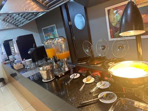 a kitchen counter with wine glasses on it at Charrua Hotel in Santa Cruz do Sul