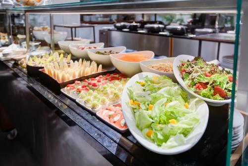 a buffet with many plates of food on a table at Radisson São Paulo Paulista in Sao Paulo