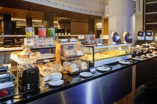 a buffet line with a bunch of food on display at Radisson São Paulo Paulista in Sao Paulo