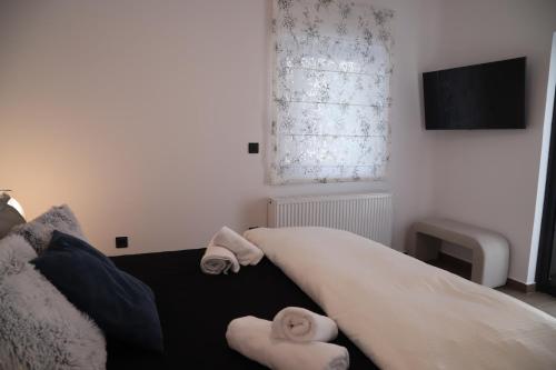 a bedroom with a bed with towels on it at Villa Achilleas by the sea in Anavissos