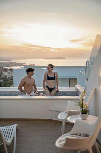 two people in a bath tub on the roof of a building at Lagon Life Spirit Boutique Hotel - Adults Only in Chania Town