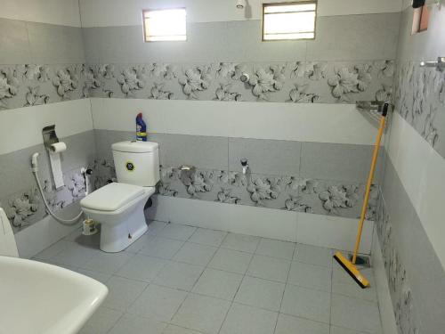 a bathroom with a toilet and a sink at Moorthy House in Kankesanturai