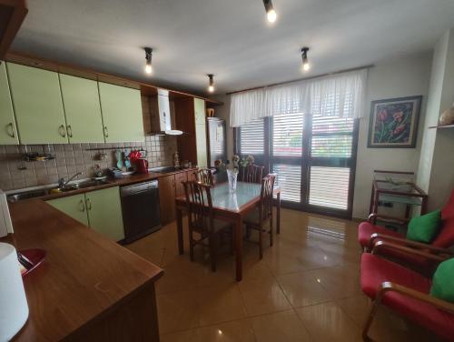 a kitchen and dining room with a table and chairs at A Flower in Tirana in Tirana