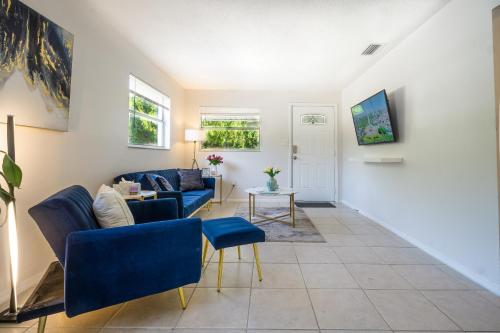 a living room with blue chairs and a couch at Sparkling Oasis near Downtown ST Pete/Beach in St. Petersburg