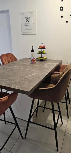 a table with two chairs and a bottle of wine at Split/Podstrana Apartment ADRIA in Podstrana