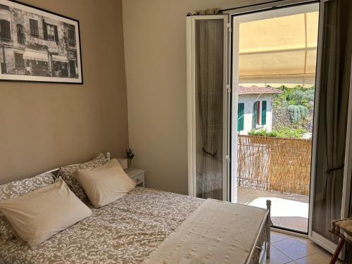 a bedroom with a bed and a sliding glass door at La Dolce Vista in Dolceacqua