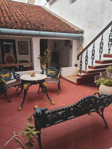 a patio with a table and chairs and stairs at Villa Mon Cheri in Pondicherry
