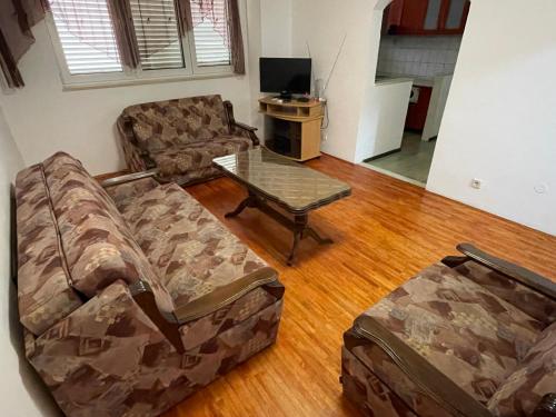a living room with a couch and a coffee table at Apartments Moreno in Budva