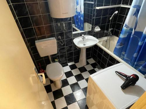 a small bathroom with a toilet and a sink at Apartments Moreno in Budva