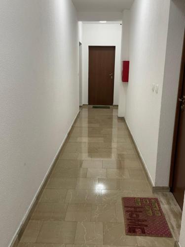 an empty hallway with a door and a tile floor at Apartments Moreno in Budva