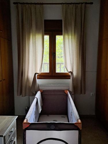 a bed in a room with a window at CENTER o'CLOCK in Xanthi