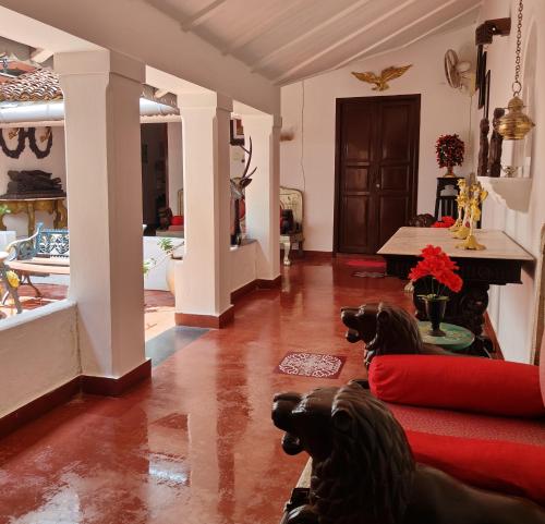 a living room with two dogs sitting on the floor at Villa Mon Cheri in Pondicherry