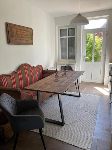 a living room with a wooden table and a couch at Landliebe Aulosen in Aulosen