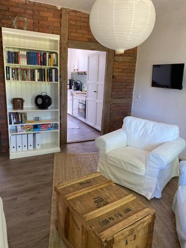 a living room with a white couch and a table at Landliebe Aulosen in Aulosen