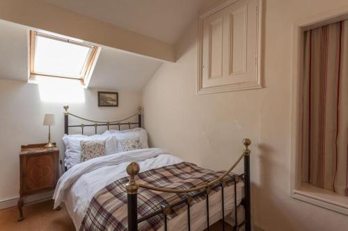 a bedroom with a bed and a window at Woodlands House in Giggleswick