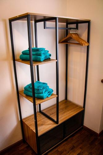 a shelf with four folded towels in a room at Appartamento Dolomiti - Fronte Piste da Sci in Auronzo di Cadore