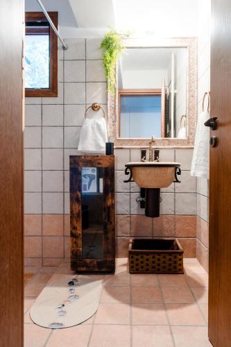 a bathroom with a sink and a mirror at Poseidon Apartments in Poros
