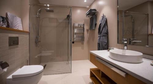 a bathroom with a shower and a sink and a toilet at Sea Breeze White Villa in Baku