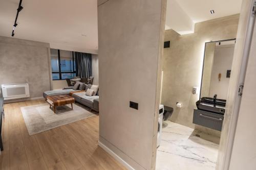 a living room with a couch and a mirror at Cosmo Comfort in Tirana
