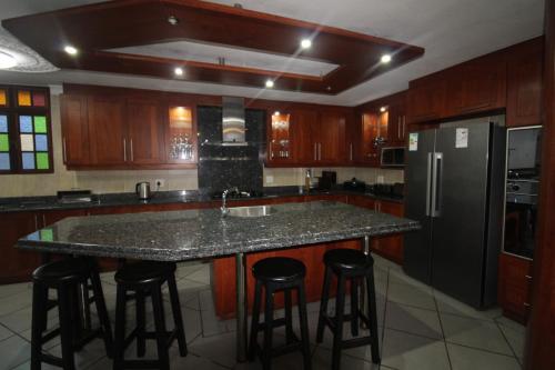 a kitchen with a large island with bar stools at Boulevard 14 in Margate