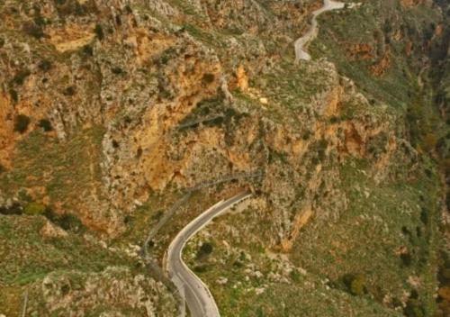 a winding road on the side of a mountain at VALENA STYLISH HOME (15 min TO ELAFONISI BEACH) in Élos