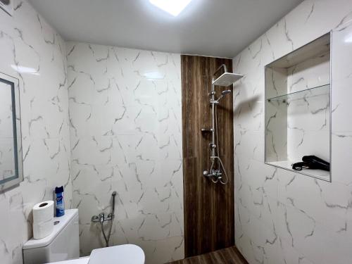 a bathroom with a toilet and a shower at OLD Tbilisi in Tbilisi City