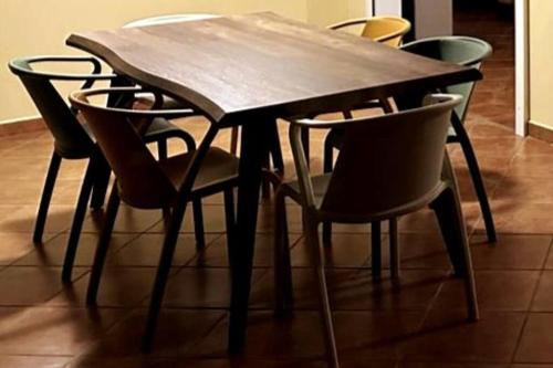a dining room table and chairs with a wooden table at Carré Vert Guadeloupe Villa Privée Piscine in Gourbeyre